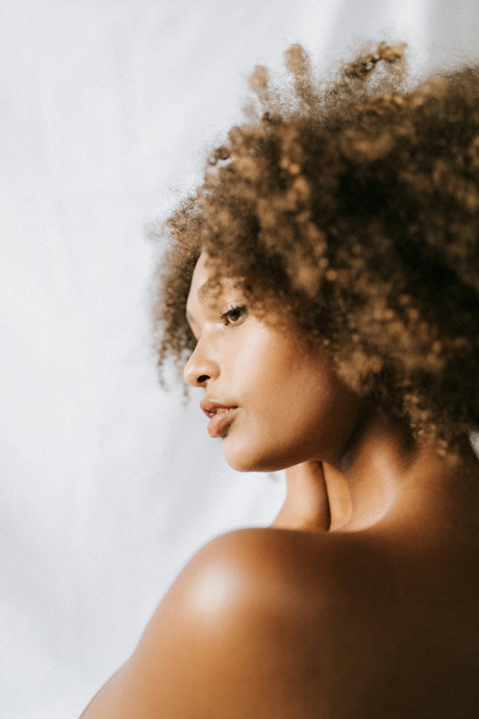 A woman in warm light, turned in profile